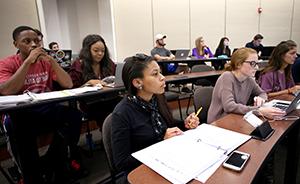 Students sitting at tables in class.